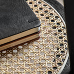 Severin Black Oak Bedside Table with Rattan Shelf - Maison Rêves UK